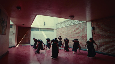 a group of women walking down a hallway