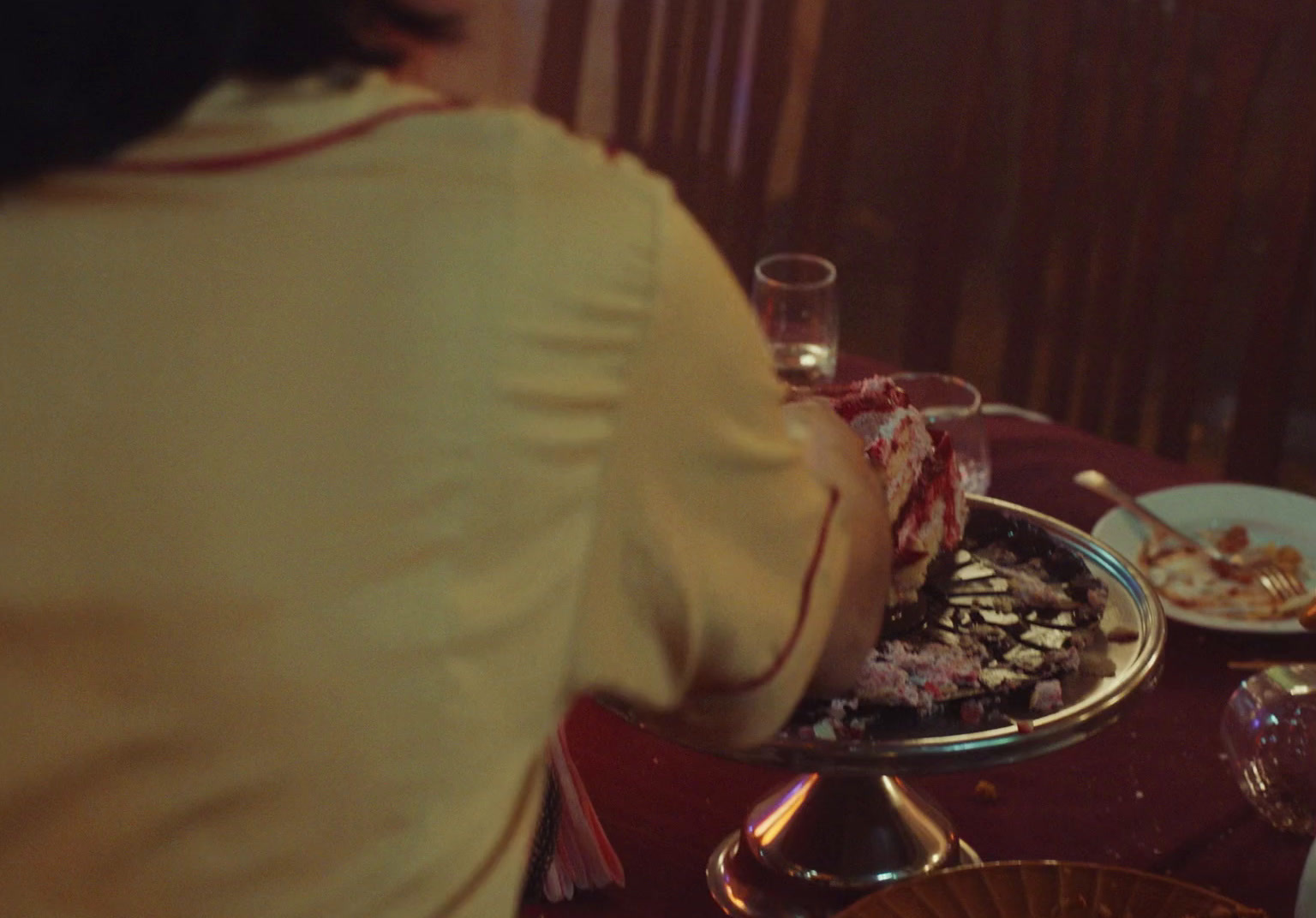 a woman sitting at a table with a plate of food