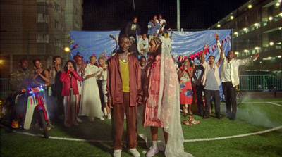 a group of people standing on top of a soccer field