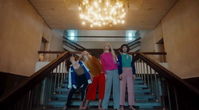 a group of women standing on top of a set of stairs