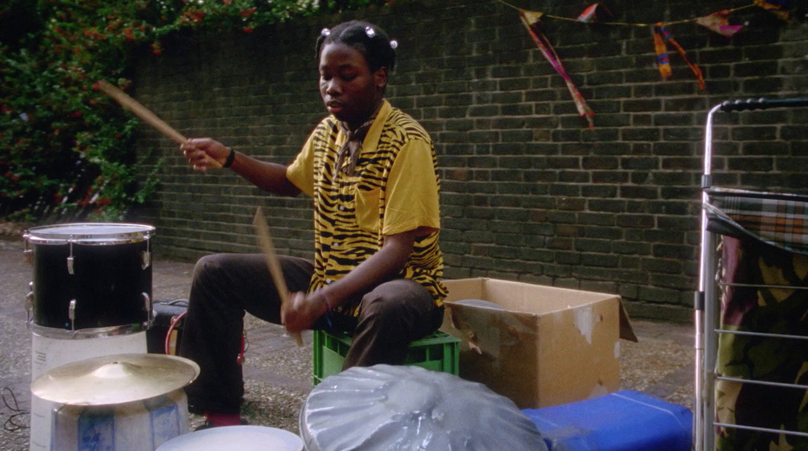 a woman sitting on a chair playing drums