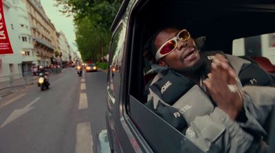 a man in sunglasses is sitting in the back of a car