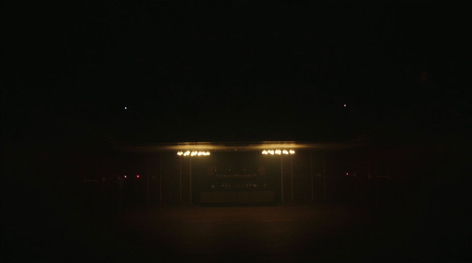 an empty parking lot at night with lights on