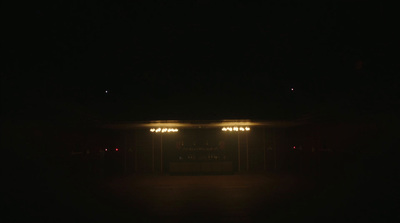 an empty parking lot at night with lights on