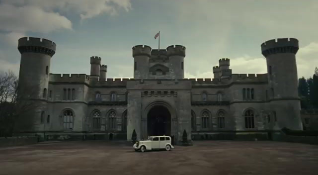 a white car parked in front of a castle