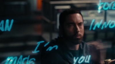 a man standing in front of a neon sign