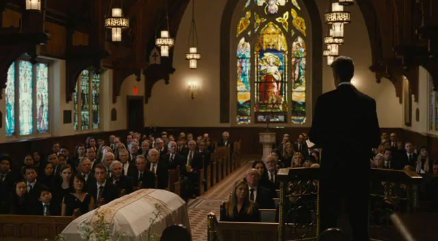 a man standing in front of a church filled with people