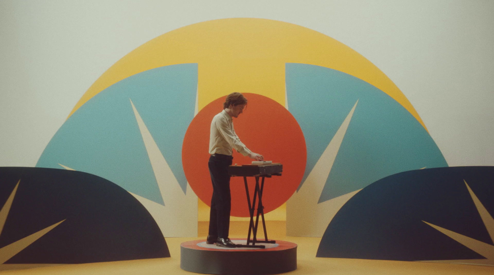 a man standing on a stool in front of a wall