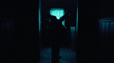 a person standing in a dark room with a light on