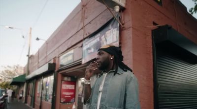 a man with dreadlocks talking on a cell phone