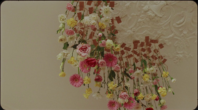 a bunch of flowers hanging from a ceiling