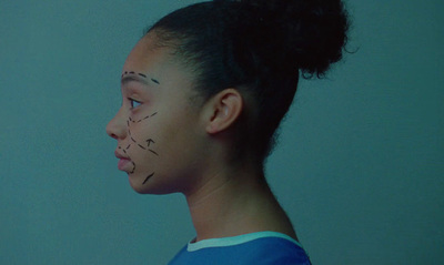 a young girl with her face painted to look like a human face