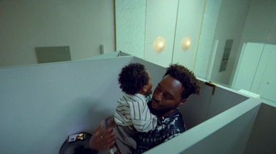 a man holding a small child in a bathroom