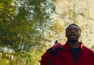 a man in a red jacket holding a red frisbee