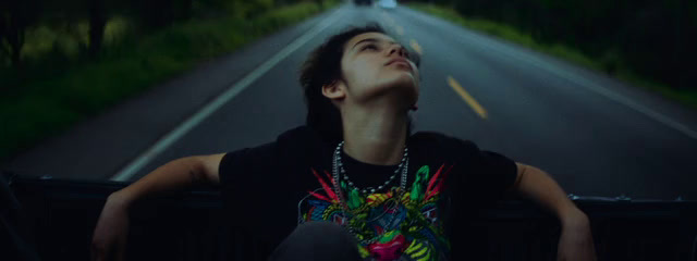 a man sitting in the back of a truck looking up