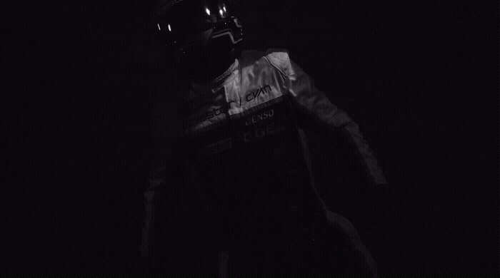 a person wearing a helmet in the dark