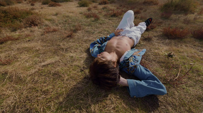 a person laying on the ground in a field