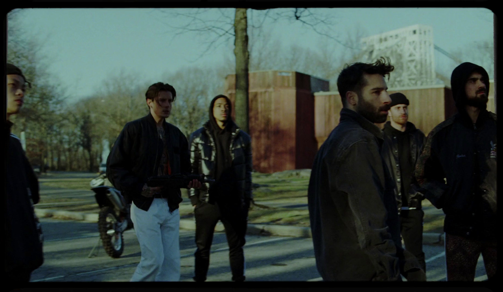 a group of people standing on the side of a road