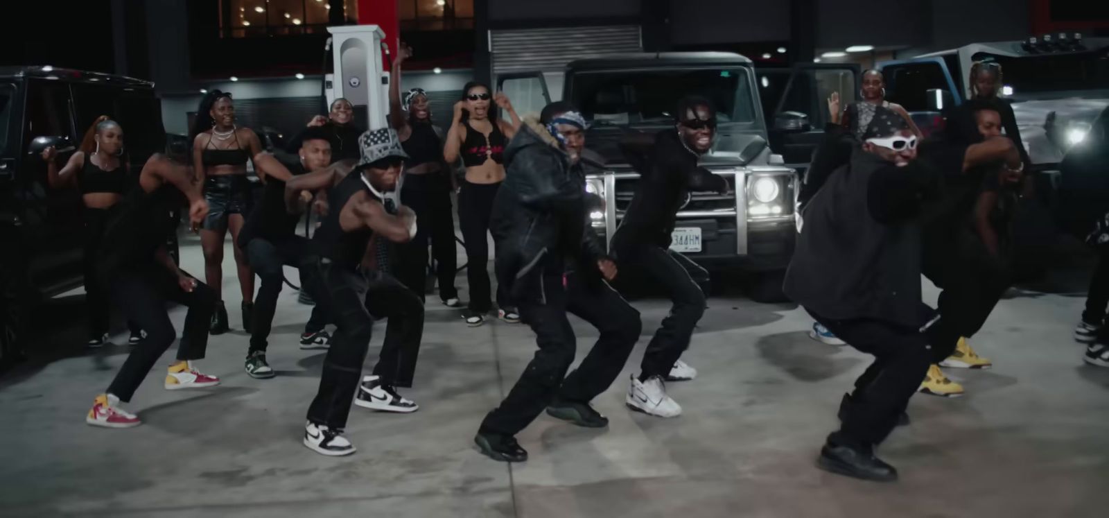 a group of people dancing in front of a truck