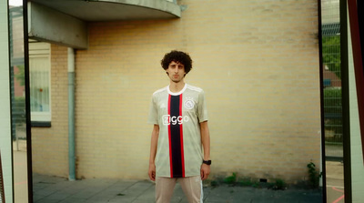 a man standing in front of a brick building