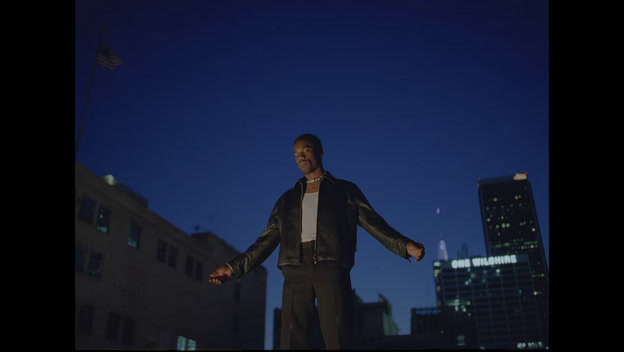 a man standing in the middle of a city at night