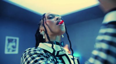 a woman with long dreadlocks standing in a room