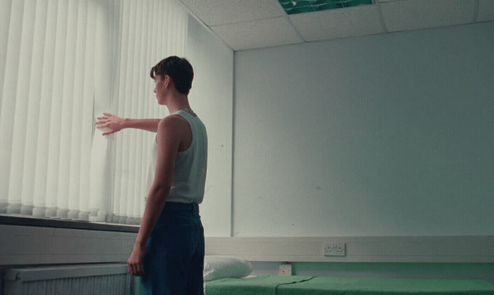 a man standing in front of a window in a room