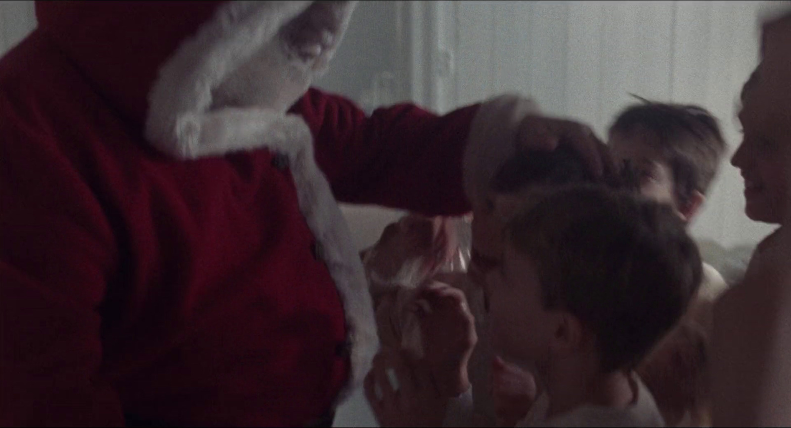 a man in a santa suit brushing his hair