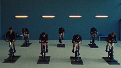 a group of people riding bikes in a room