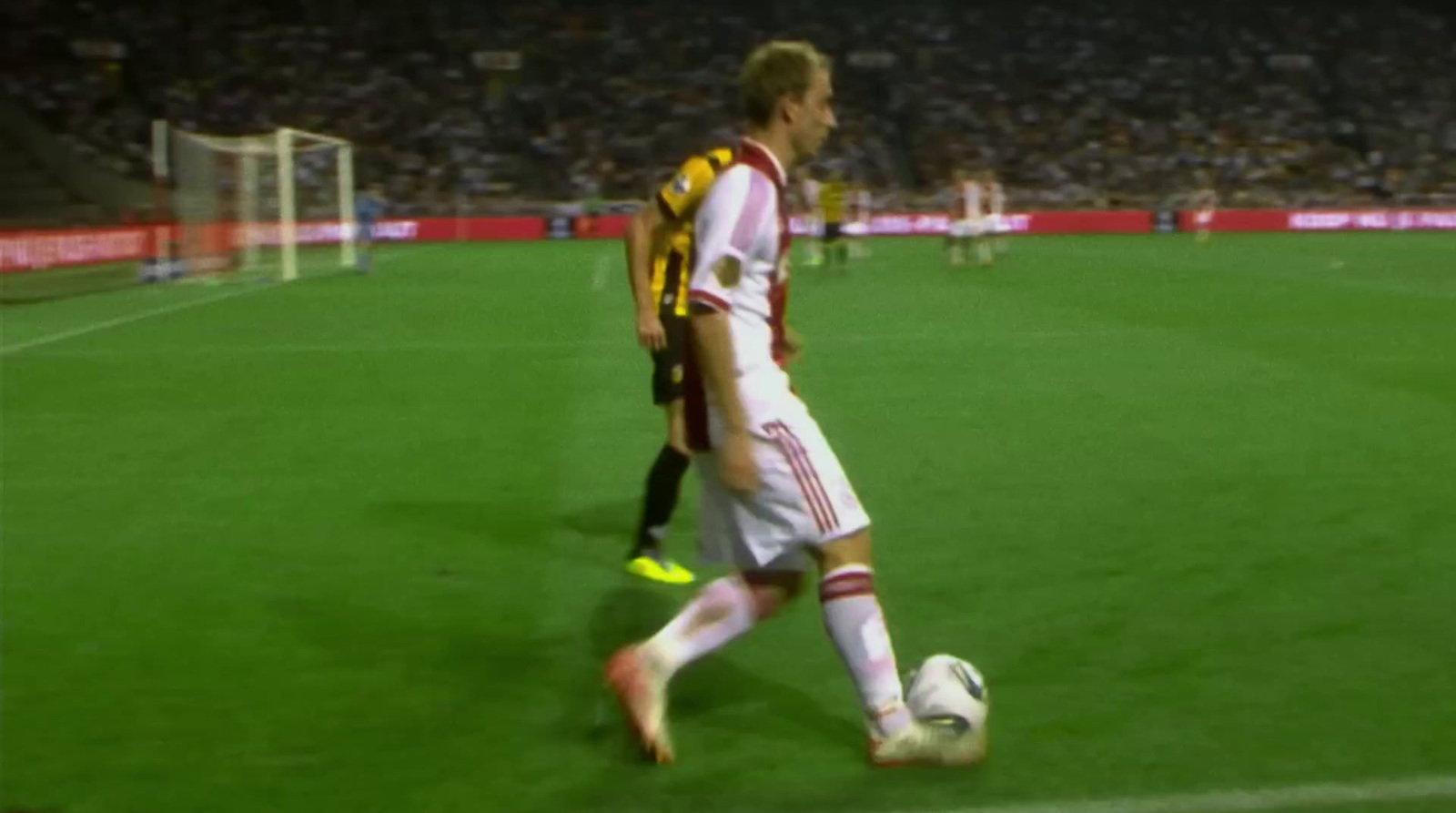 a man kicking a soccer ball on a field