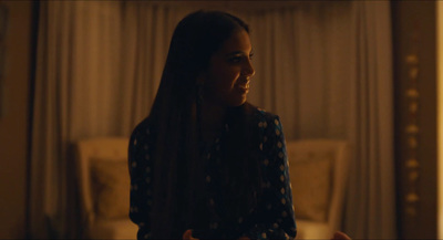 a woman with long hair standing in a room