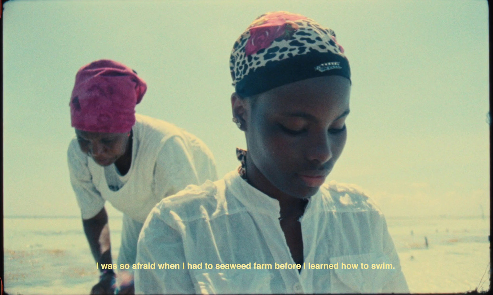 a couple of women standing next to each other on a beach