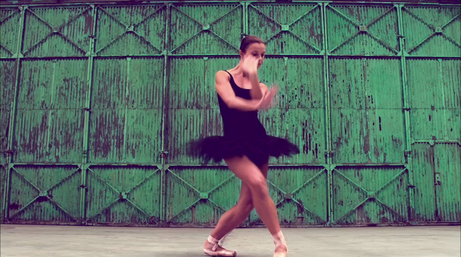 a woman in a black dress is dancing