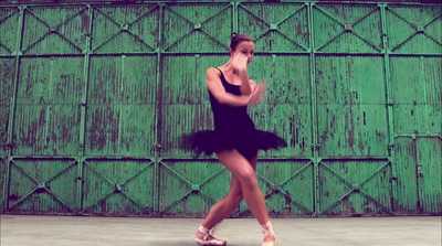 a woman in a black dress is dancing