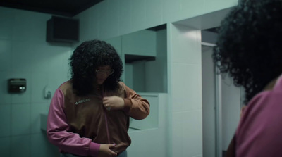 a woman brushing her hair in front of a mirror