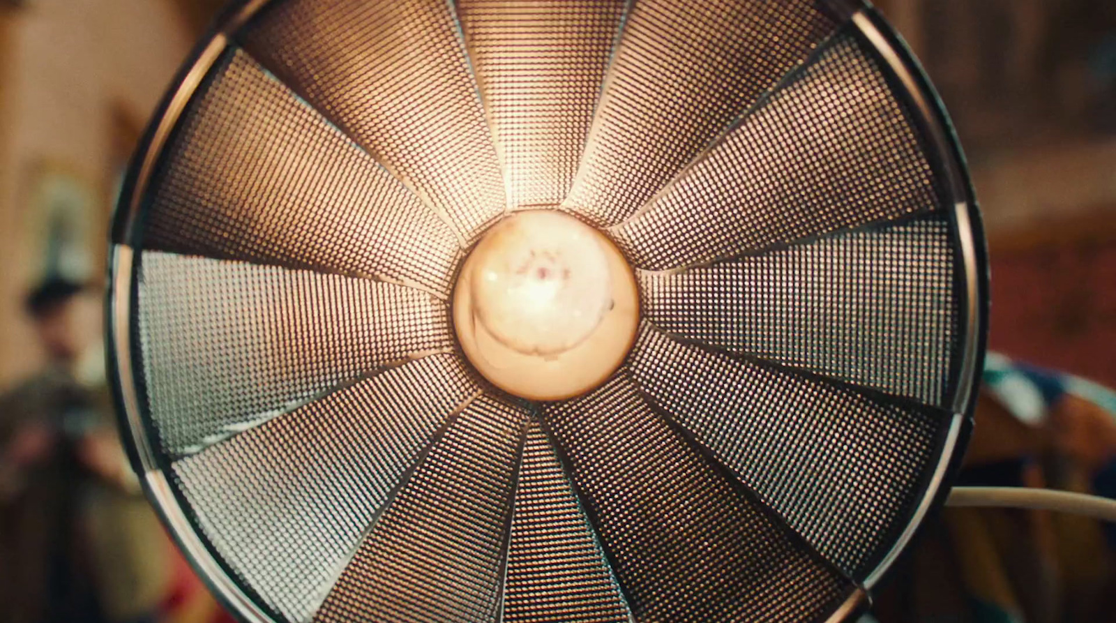 a close up of a metal fan with a light on it