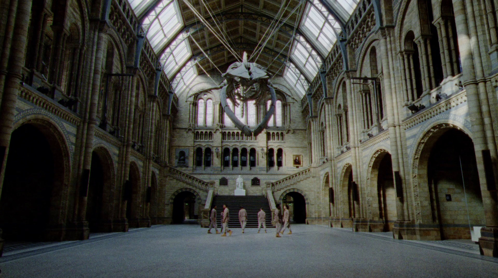 a group of people standing inside of a large building