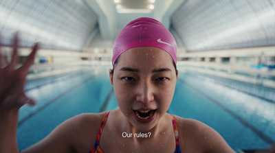 a woman in a swimming cap making a face