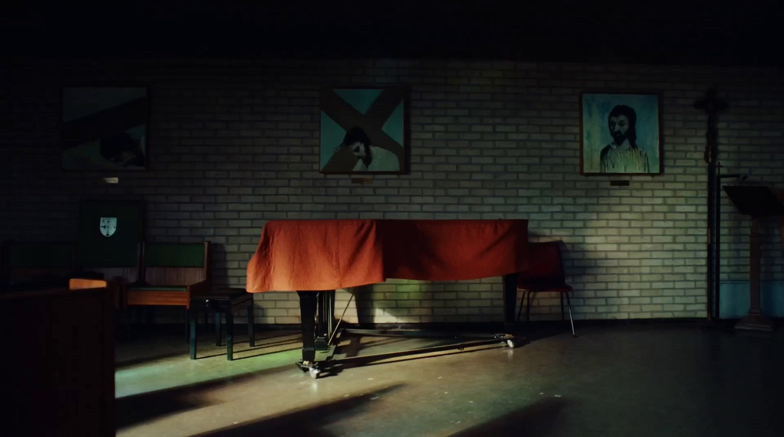 a room with a brick wall and a table with a red cloth on it