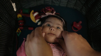 a woman holding a baby in a stroller