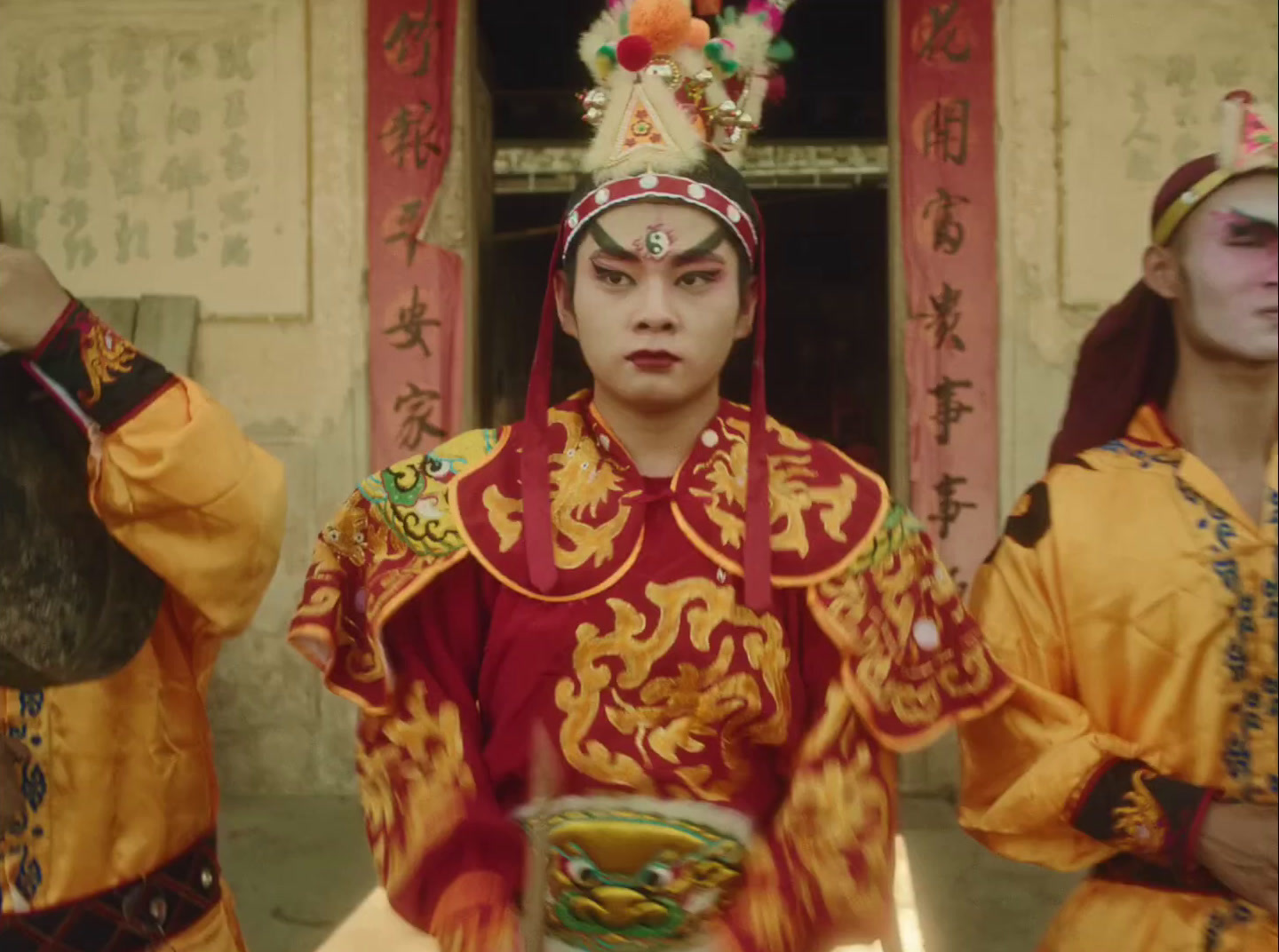 a group of men in chinese costumes standing next to each other