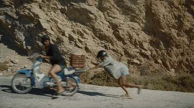 a couple of people riding on the back of a motorcycle