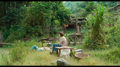 a person sitting at a table in a field