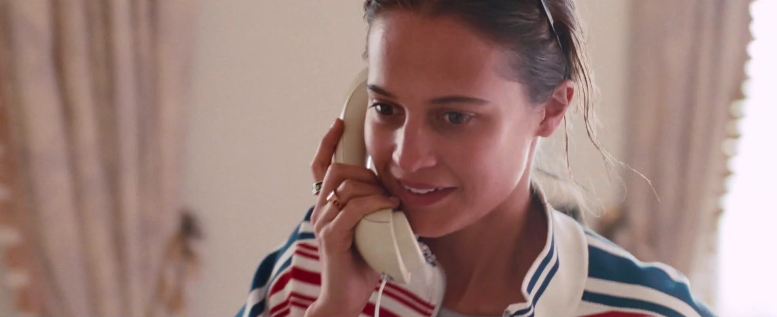 a woman talking on a phone in a room