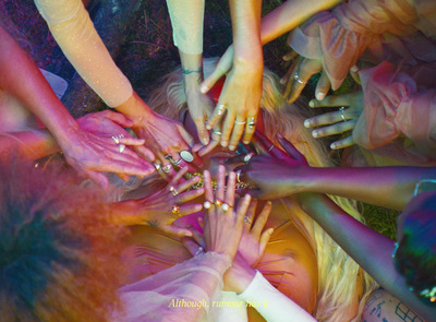 a group of people with their hands together