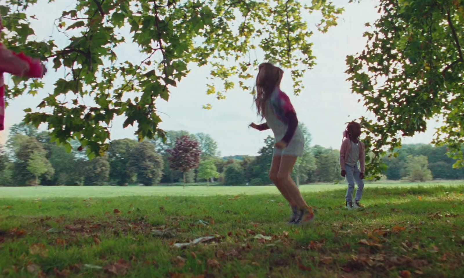 a group of young people playing a game of frisbee