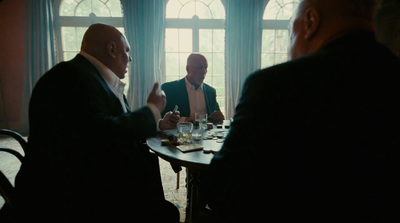 a group of men sitting around a table