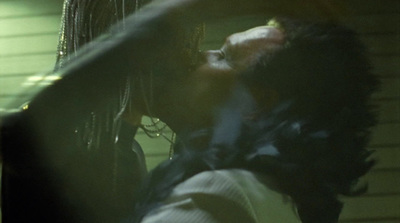 a man and a woman kissing in the dark