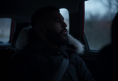 a man sitting in the back seat of a car