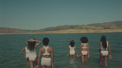 a group of women standing in the water